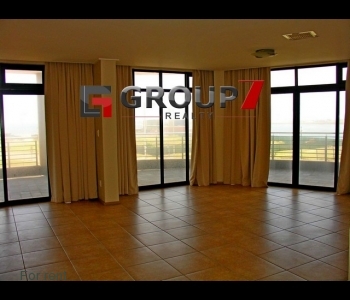Large open plan lounge with double 
volume windows