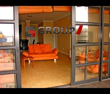 Double volume windows and sliding door leading onto balcony