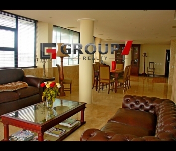 Grand lounge area with travertine floors