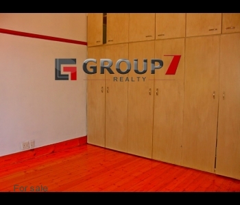 Bedroom 1 with gleaming wooden floors and BIC
