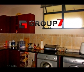 Kitchen with washing machine and tumble dryer