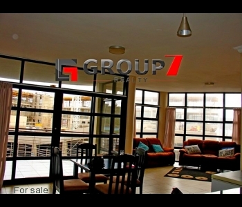 Spacious lounge and dining area with double volume windows