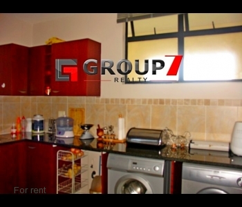 Kitchen with washing machine and tumble dryer