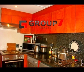 Kitchen with washing machine and tumble dryer