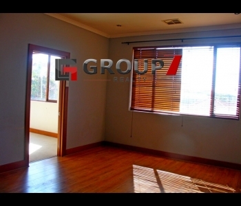 Spacious lounge with wooden flooring