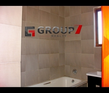 Bathroom fully tiled with tub